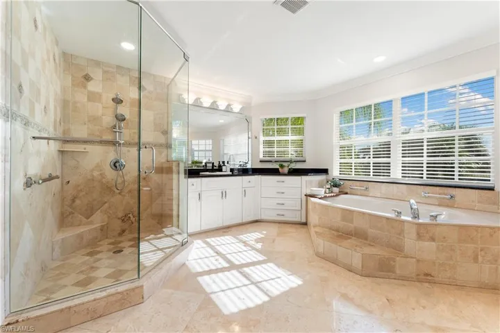 Full bath with vanity, a garden tub, a stall shower, ornamental molding, and recessed lighting