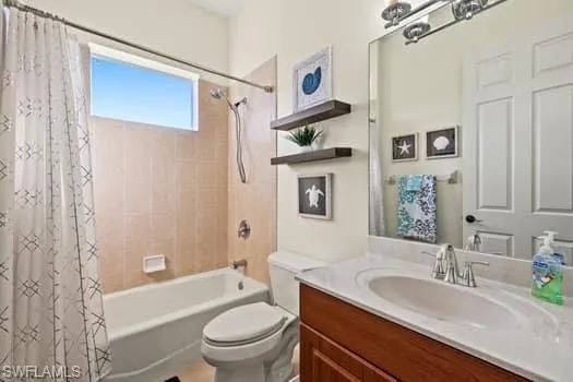Full bathroom with vanity, toilet, and shower / bath combo