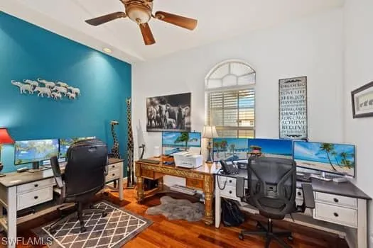 Office with hardwood / wood-style flooring and ceiling fan