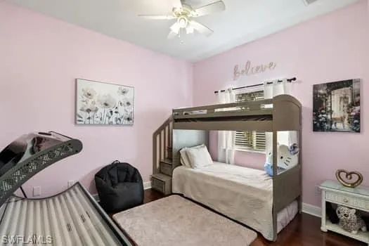 Bedroom featuring ceiling fan and dark hardwood / wood-style flooring