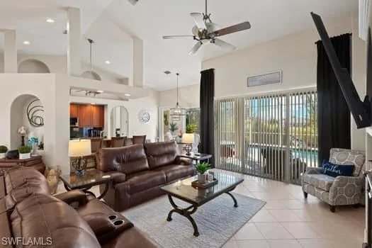 Living room with ceiling fan and light tile patterned flooring