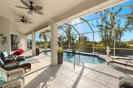 View of pool featuring ceiling fan, a lanai, and a patio area