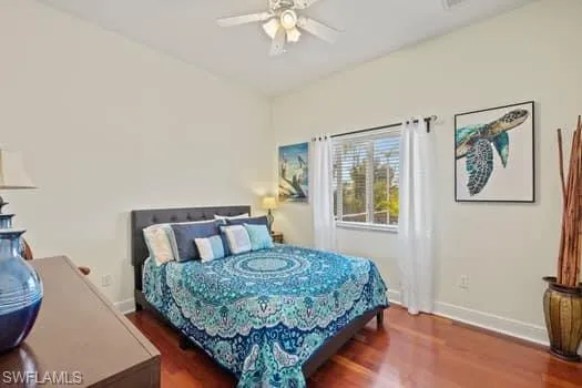 Bedroom featuring dark hardwood / wood-style flooring and ceiling fan
