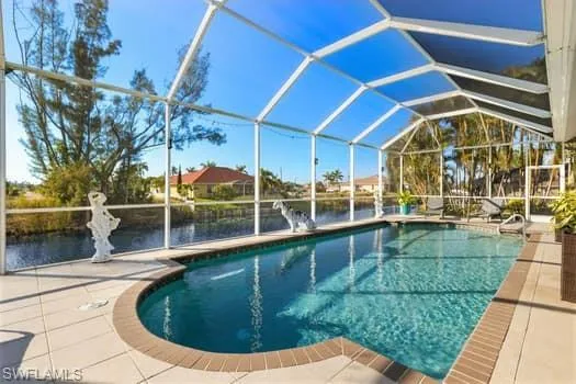 View of pool featuring a water view, a patio, and a lanai