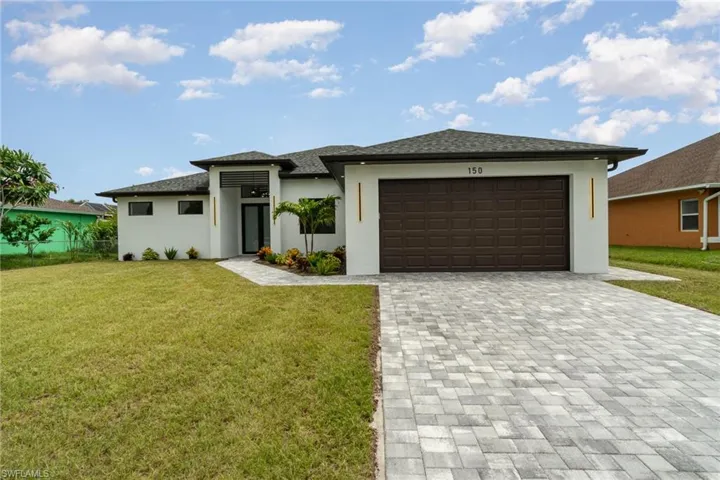 Prairie-style home with a garage and a front yard
