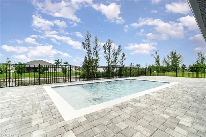 View of pool with a patio area- screen cage to be added