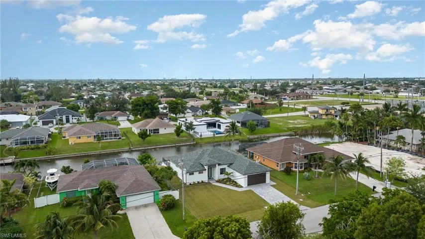 Birds eye view of property with a water view- screen cage to be added
