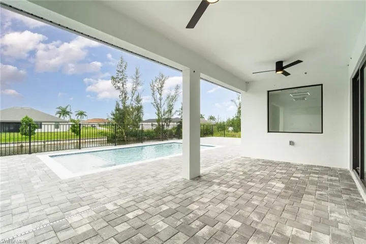 View of pool with ceiling fan and a patio area- screen cage to be added