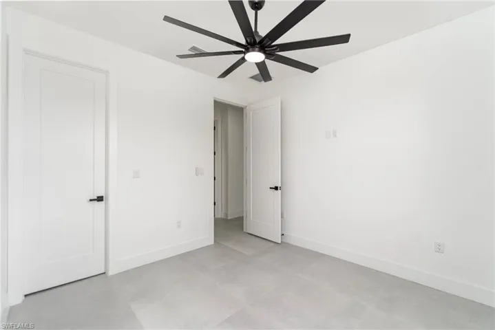 Unfurnished room featuring light tile patterned floors and ceiling fan