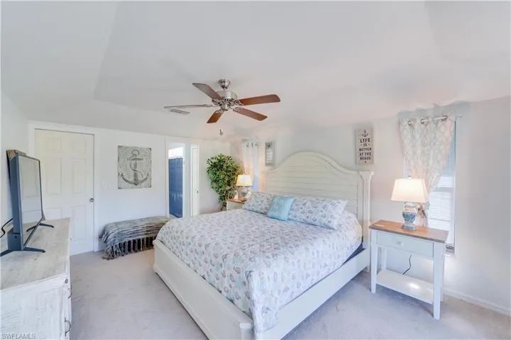 Bedroom with light carpet and ceiling fan