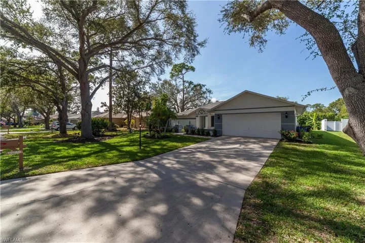 Single story home featuring stucco siding, a garage, and concrete driveway