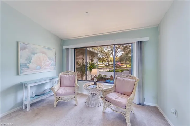 Sitting room with light carpet and lofted ceiling
