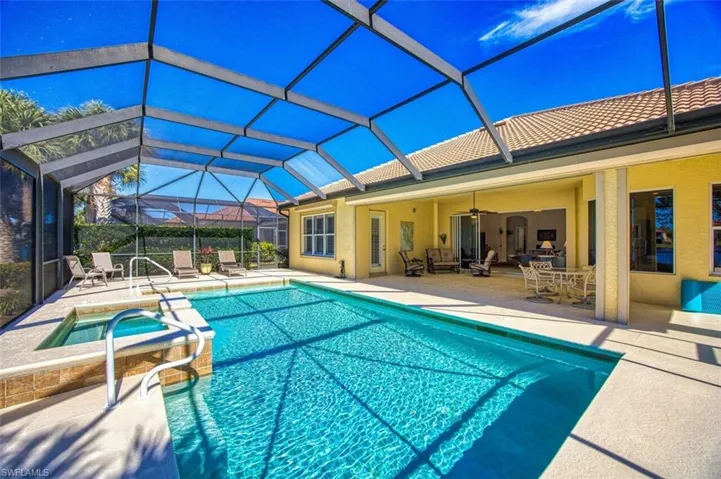 View of swimming pool featuring an in ground hot tub, a lanai, ceiling fan, and a patio