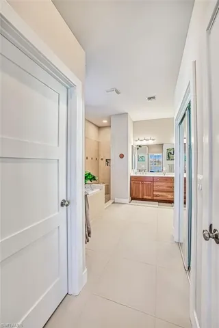 Bathroom with vanity, tile patterned floors, and separate shower and tub