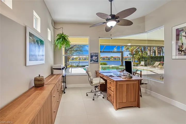 Tiled office featuring ceiling fan