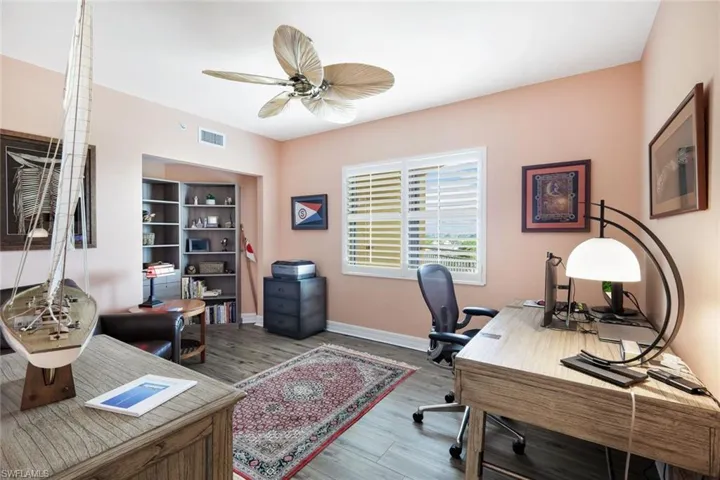 Home office featuring ceiling fan and wood-type flooring