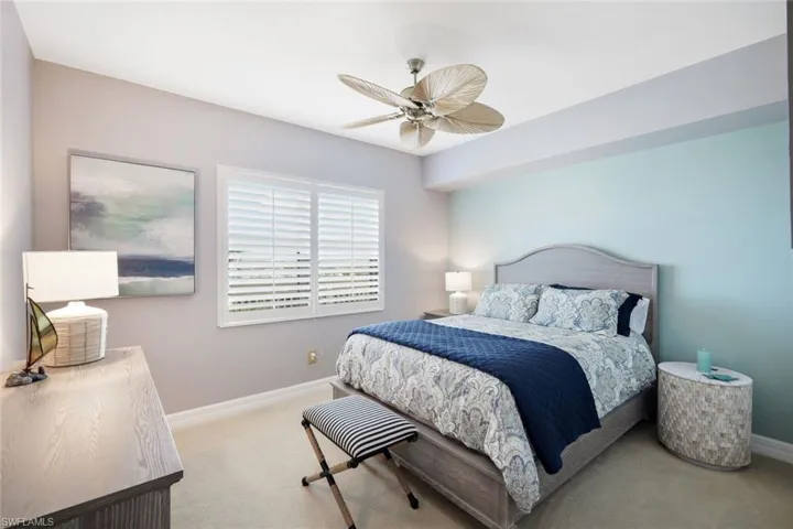 Bedroom featuring light carpet and ceiling fan