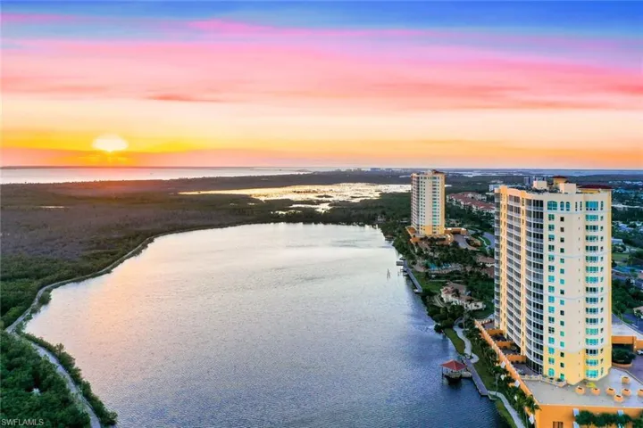 Aerial view at dusk featuring a water view