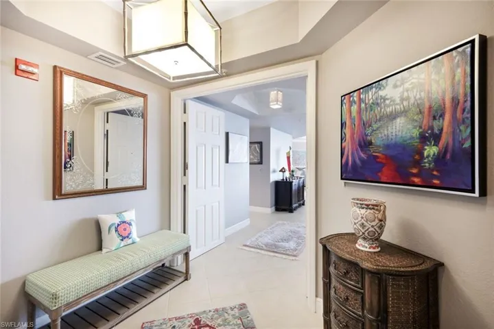 Corridor featuring light tile patterned flooring
