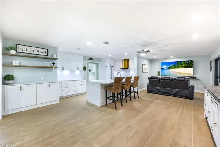 Kitchen and living room are open to one another.  Notice the coffee bar...perfect for preparing your favorite cocktails, morning coffee OR additional storage!