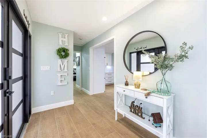 Entryway leads to the main living room and kitchen areas.  Notice the front door!