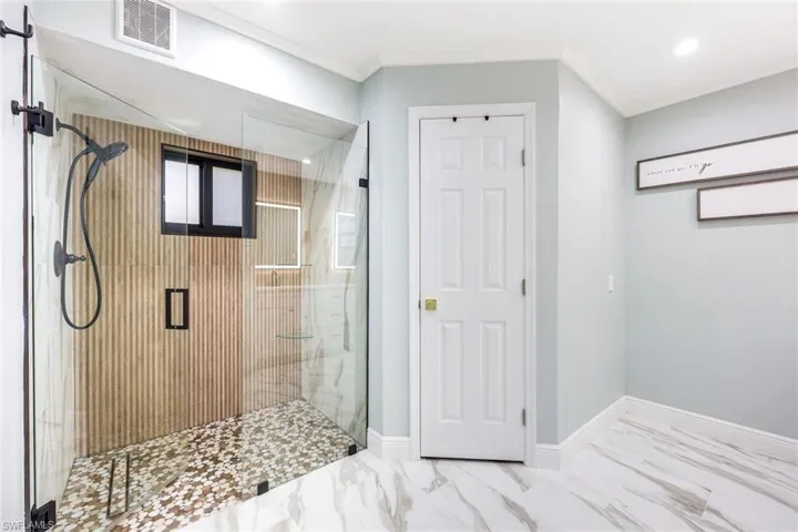 The primary bathroom has been elegantly updated featuring a stunning walk-in shower!