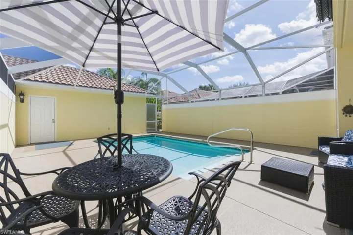 Outdoor pool with a patio area, a lanai, and a sunroom