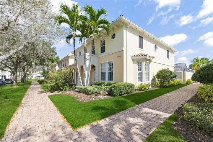 View of side of home featuring stucco siding and a lawn