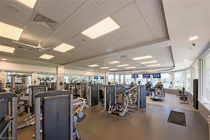 Gym featuring a paneled ceiling and a ceiling fan