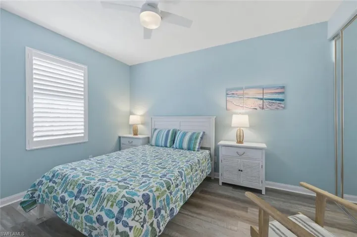 Bedroom with wood finished floors and a ceiling fan