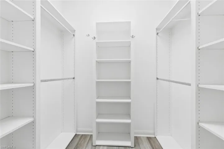 Walk in closet featuring light wood-style flooring