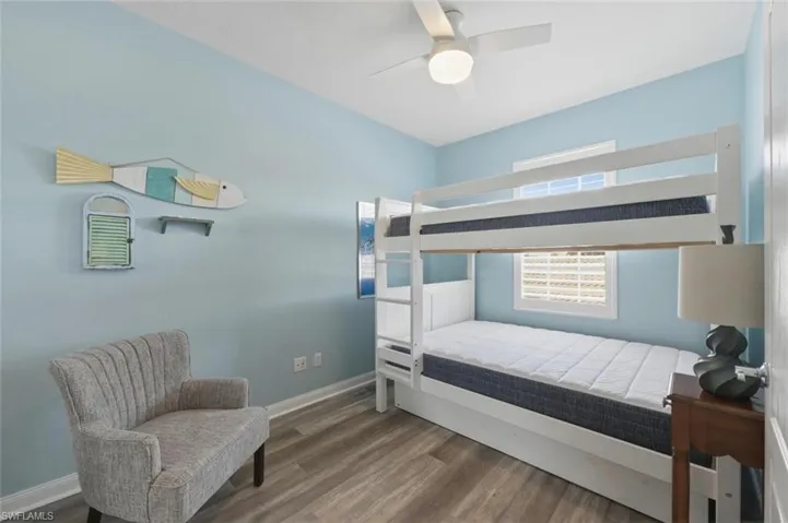 Bedroom featuring wood finished floors and a ceiling fan