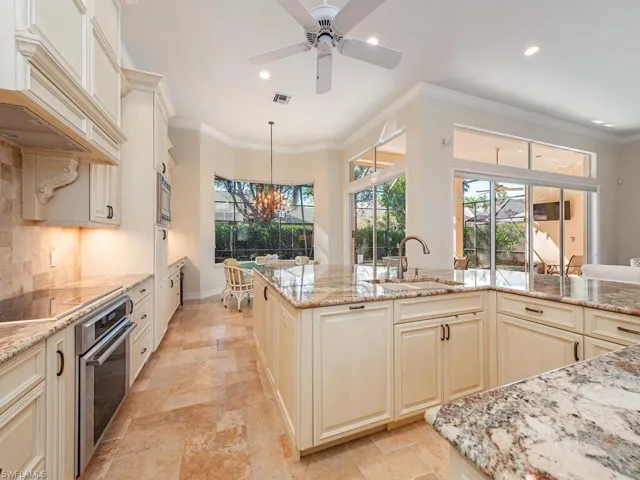 Gourmet Kitchen with light stone countertops and a bonus sink near the kitchen table.