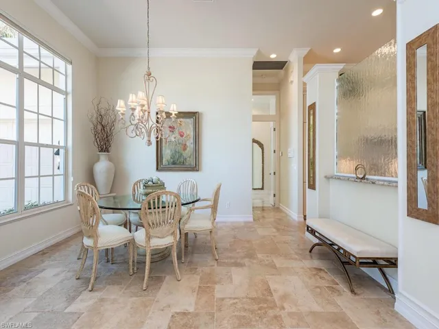 Dining room featuring crown molding and an inviting chandelier