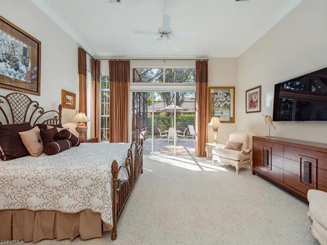 Spacious Master Bedroom, crown molding and access to outside pool and spa.