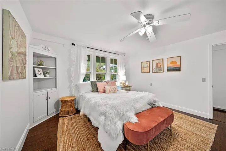 Bedroom with dark wood-type flooring and ceiling fan