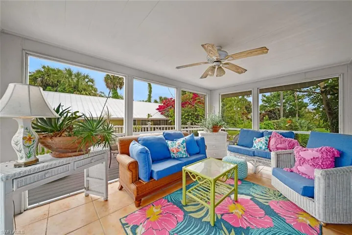 Sunroom / solarium featuring ceiling fan