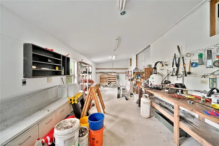 Miscellaneous room with a workshop area and vaulted ceiling