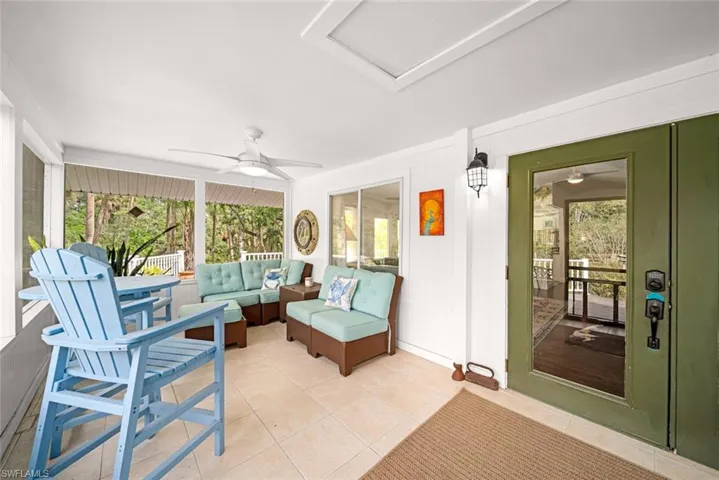 Sunroom / solarium featuring ceiling fan
