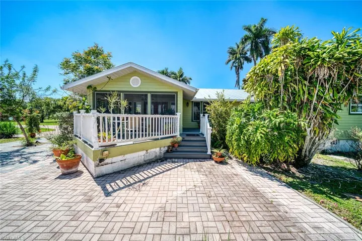 View of front of property with a sunroom