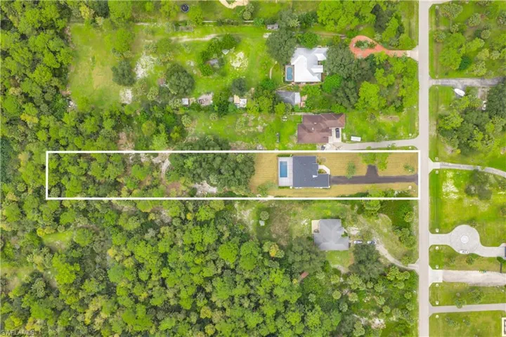 Aerial perspective of suburban area with property parcel outlined