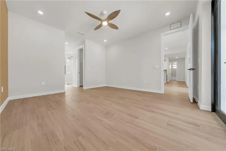 Spare room with light wood finished floors, recessed lighting, and a ceiling fan