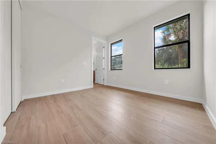 Empty room featuring light wood-type flooring and baseboards