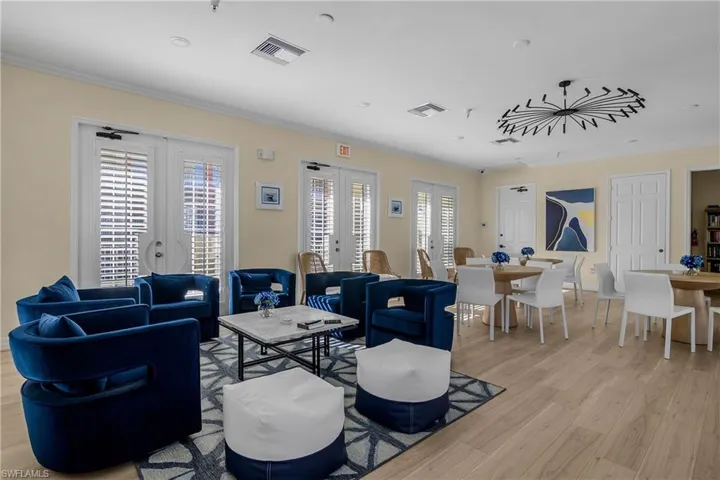 Living room with french doors, crown molding, and light wood-style flooring