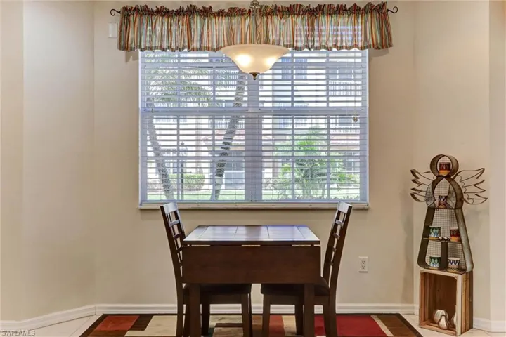 Sunny dining nook flooded with natural Florida light — great flex space for breakfast or home office