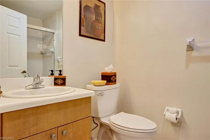 Full bathroom with dual vanity and walk-in shower stall