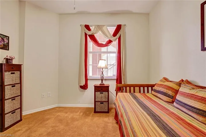 Guest bedroom with carpet and natural light