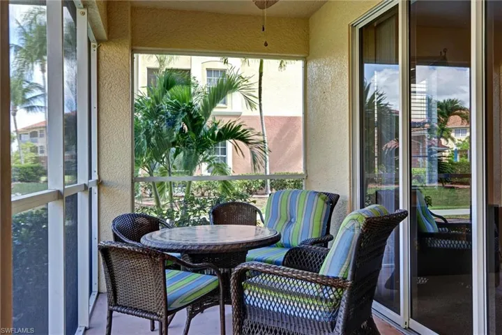 Spacious screened lanai with textured accent wall — private outdoor retreat in this Cape Coral condo