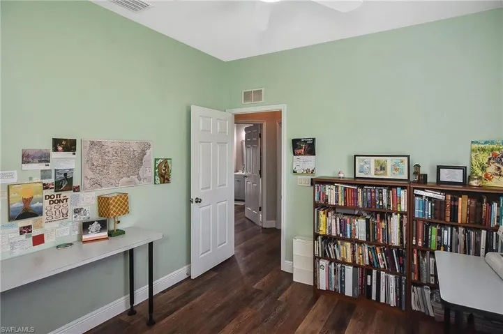 Office featuring dark wood-type flooring and baseboards