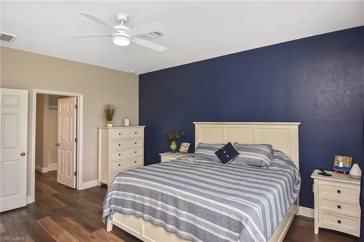 Bedroom with dark wood-style floors and a ceiling fan